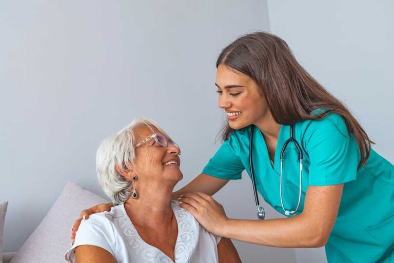 Adult daughter and older mother reviewing a care plan together at a kitchen table.